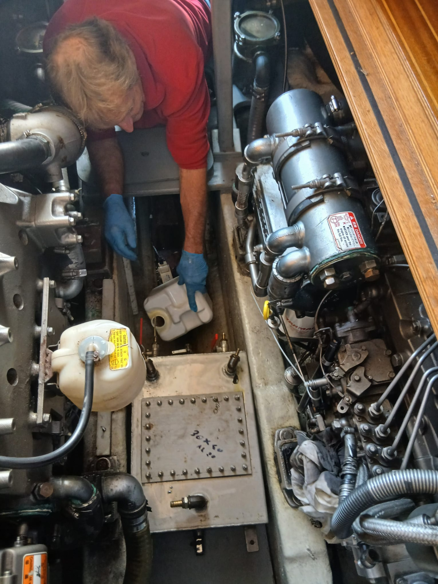 Paolo Carasso servicing an engine inside a sailing yacht