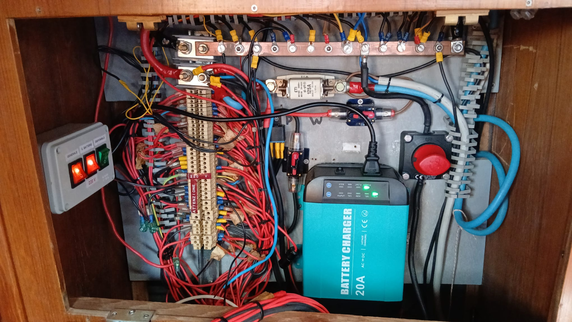 Rewired 12 V electrical panel with new battery charger on a sailing yacht
