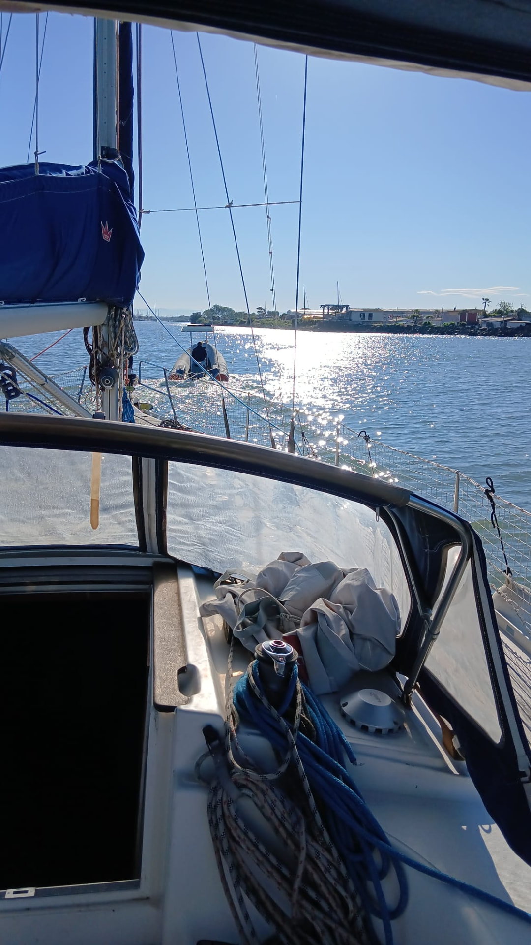 Sailing yacht motoring in calm water on the Italian coast