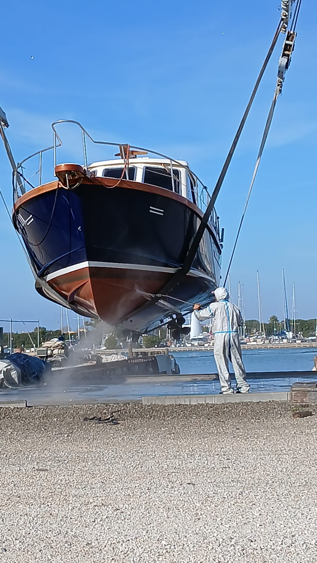 Sailing yacht lifted by a travel lift for hull works
